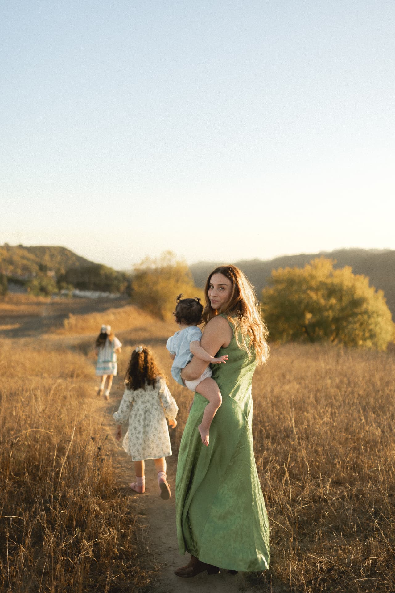 Mother and daughter in coordinated neutral outfits outdoors