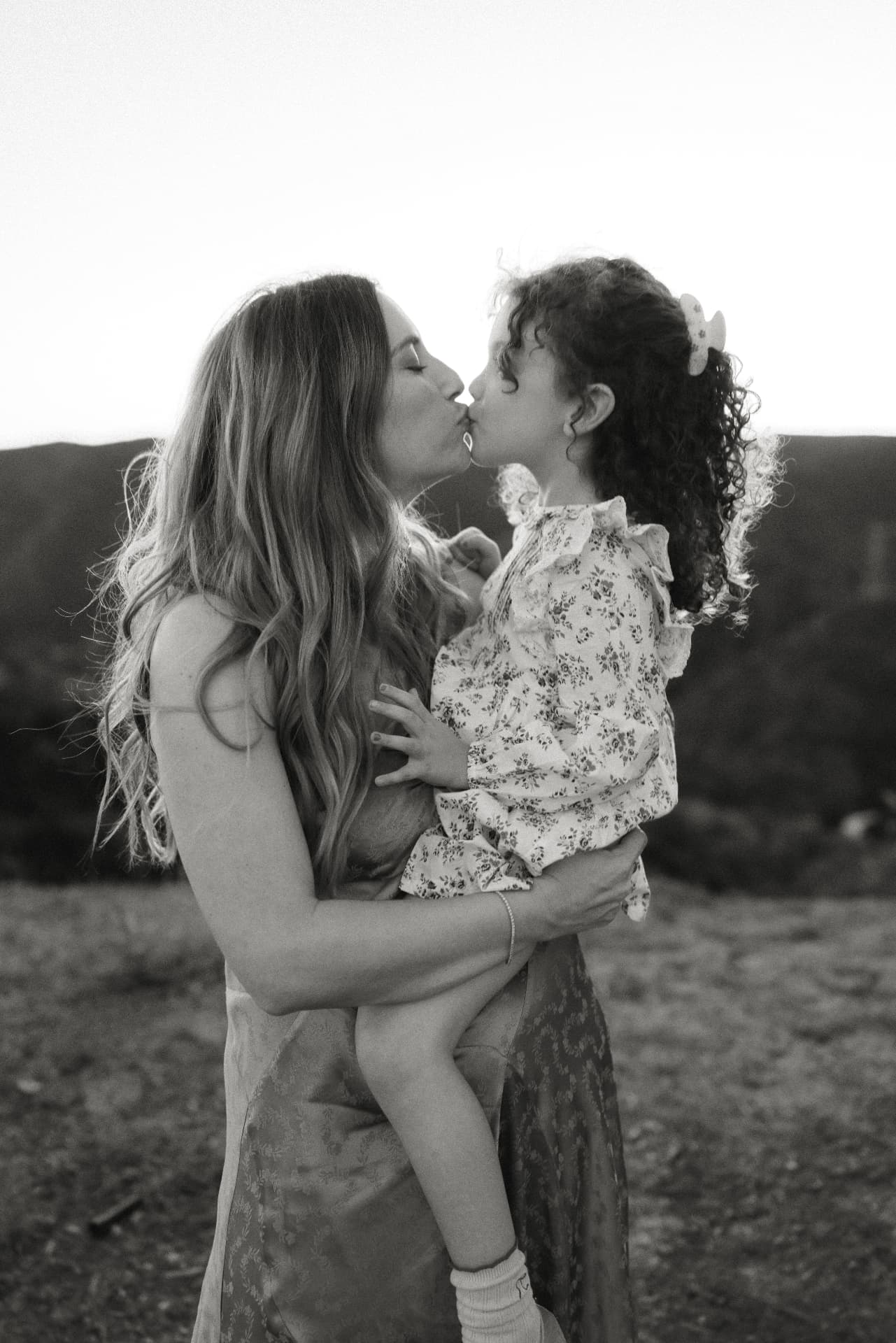 Black and white portrait of a mother holding her daughter